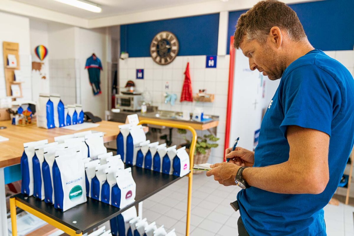 Christoph Sauser checking inventory at HORIZONTE COFFEE ROASTERS in Leysin, Switzerland