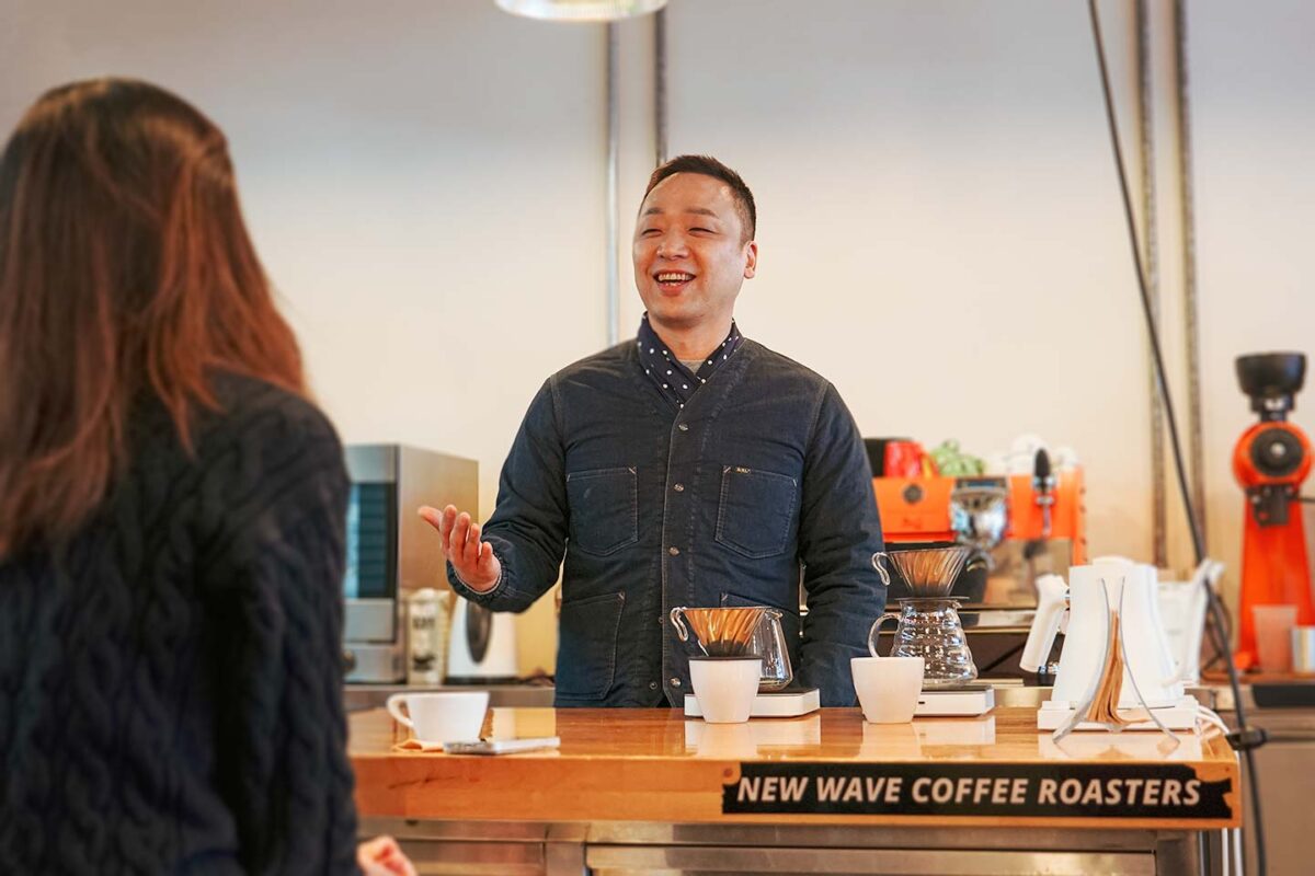 Chatting with a customer at New Wave Coffee Roasters, a specialty coffee roaster in Seoul, South Korea